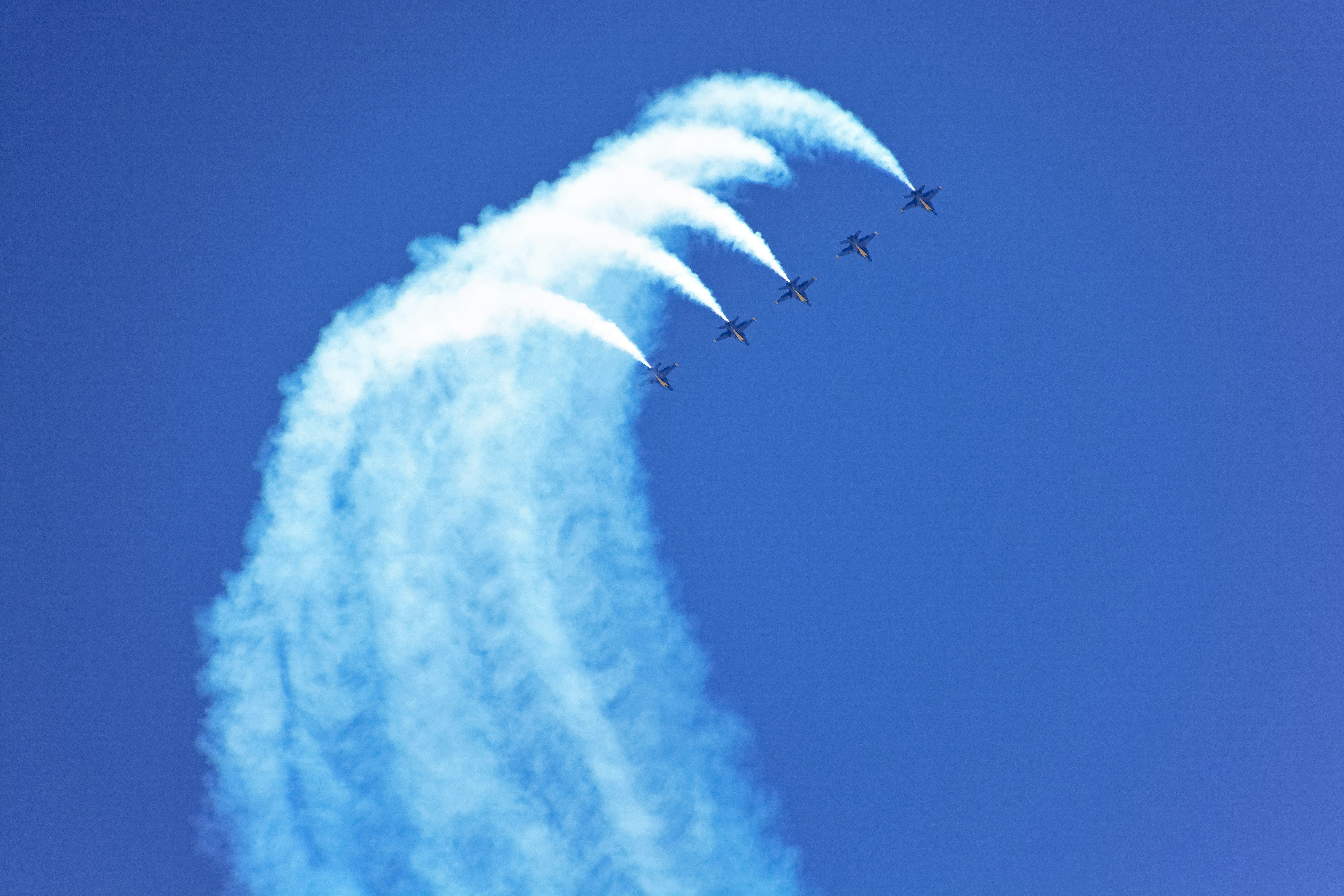 birds flying over the clouds during daytime